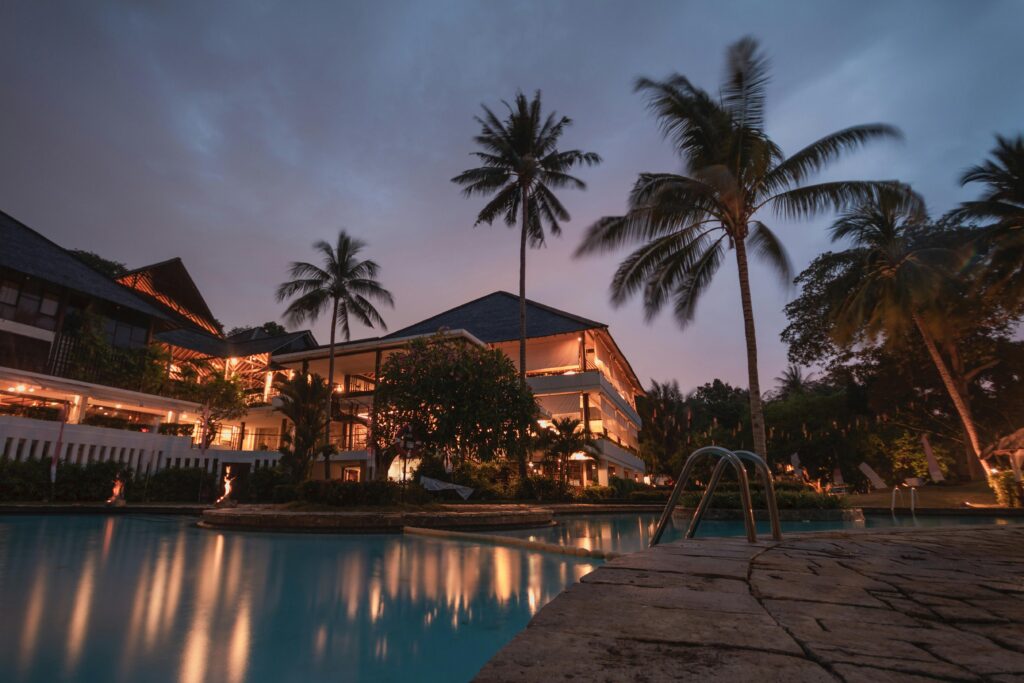 pexels-photo-258154-258154 Luxurious tropical resort with swimming pool and palms at dusk, perfect for a tranquil vacation.