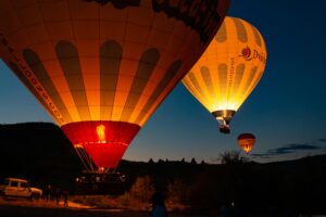 Colorful hot air balloons preparing for flight at sunrise in beautiful Cappadocia, Turkey.